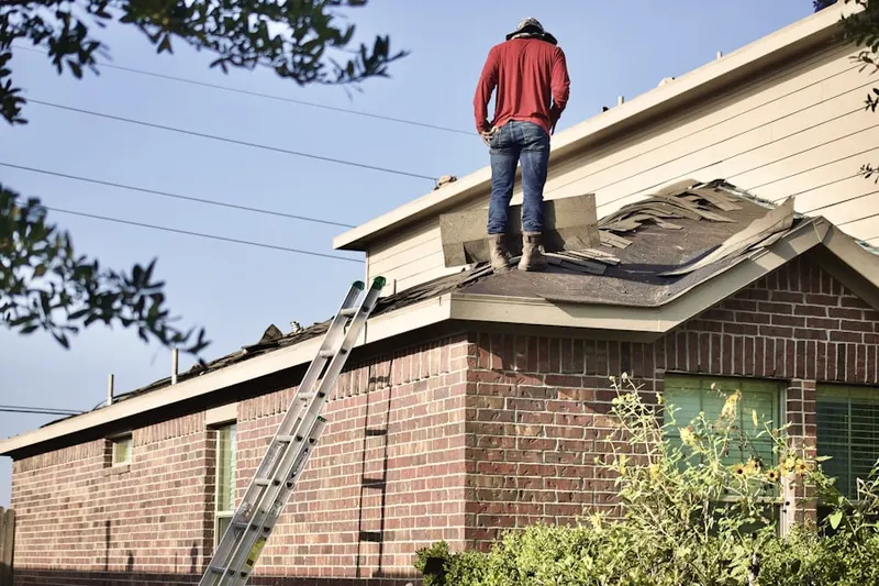Professional roofer working on a residential roof in Sterling Ridge